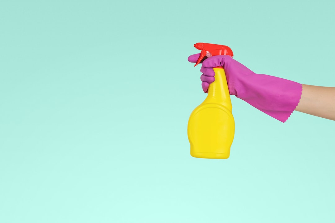 A person cleaning a living room with various cleaning supplies, showcasing common cleaning mistakes like using the wrong product or neglecting certain areas.
