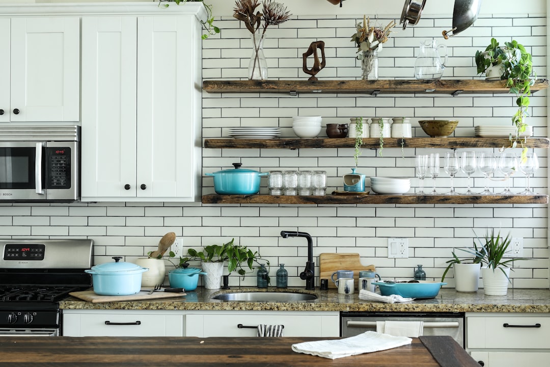 A well-organized small kitchen with efficient storage solutions, showcasing shelves, containers, and space-saving furniture.