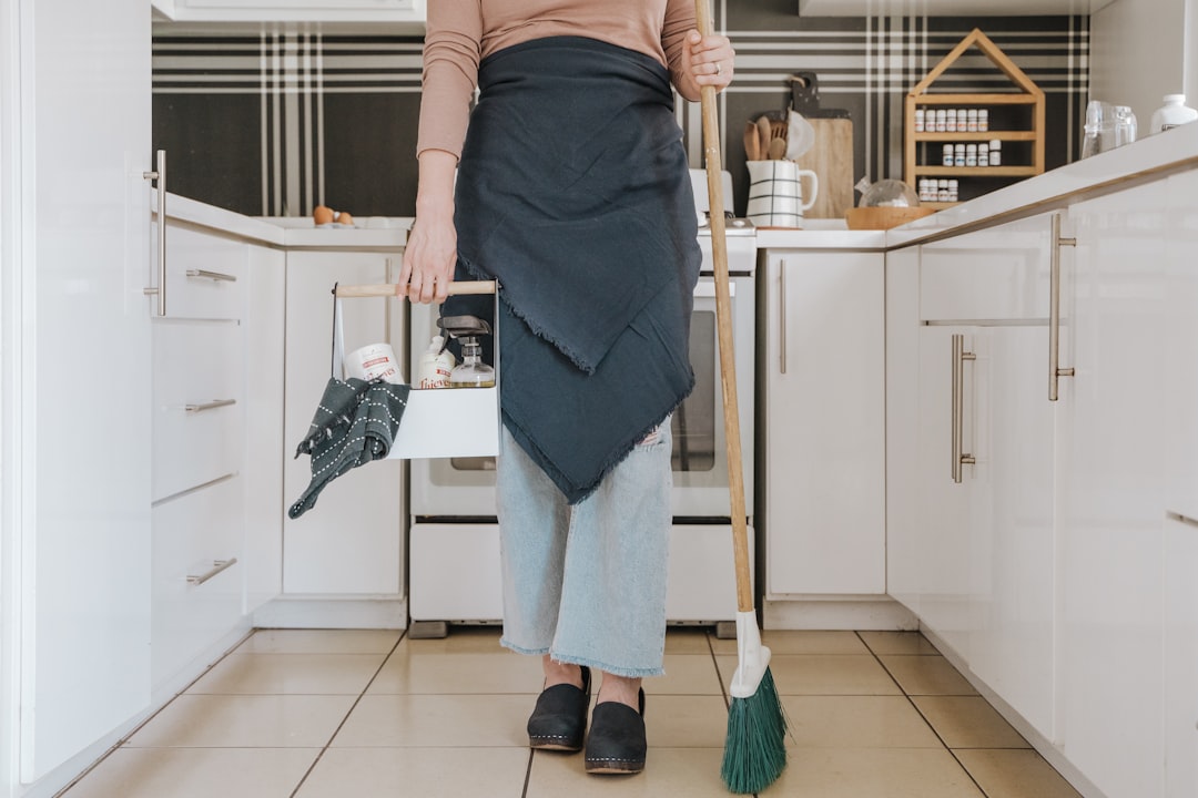 A tidy home with cleaning supplies and a planner on a table, symbolizing organization and cleanliness.