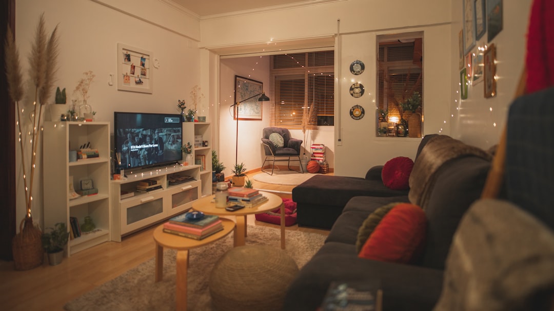 A warm and inviting living room with soft textures, warm lighting, and personal decor elements.